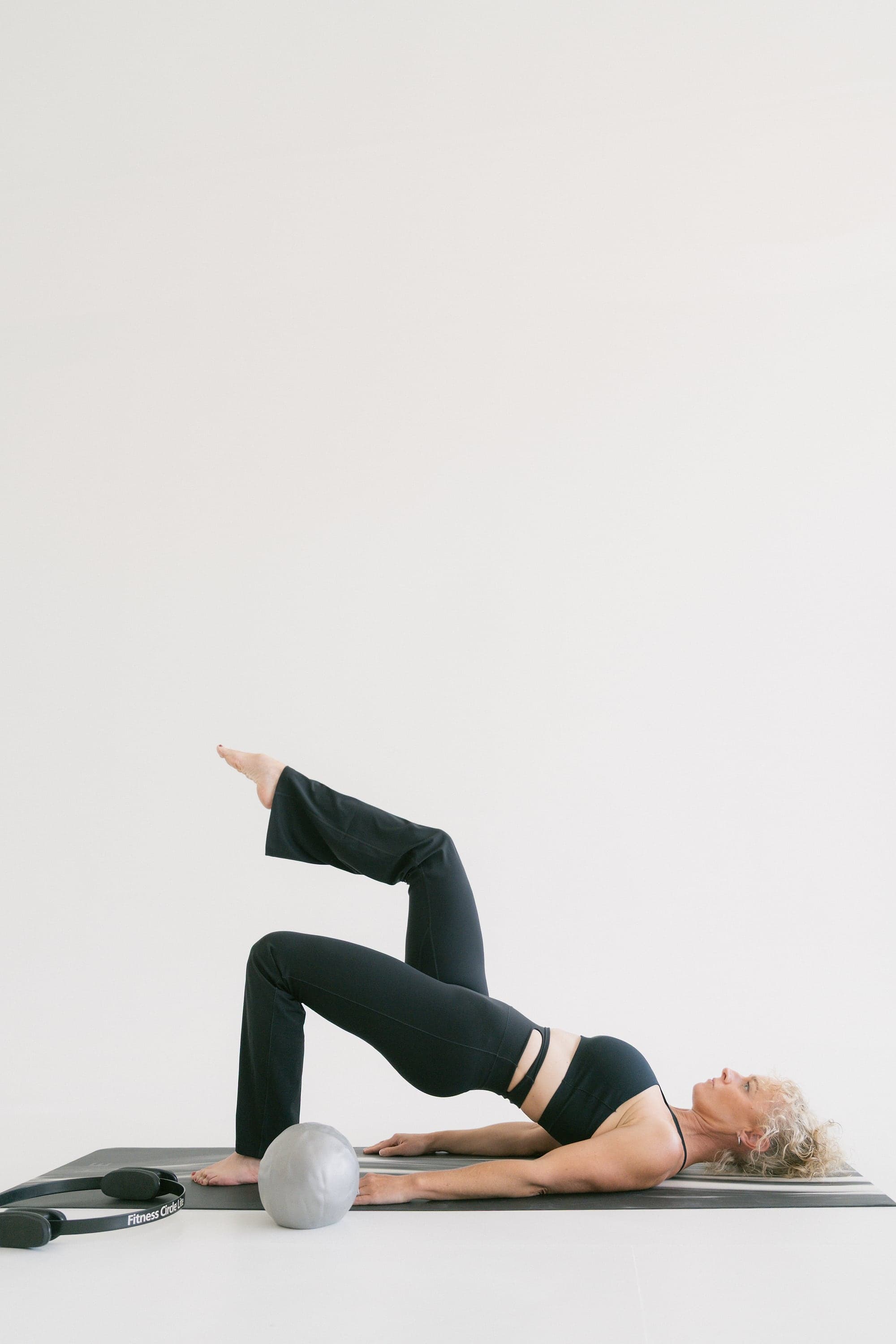 Melanie Sakavaras practising a Pilates bridge pose
